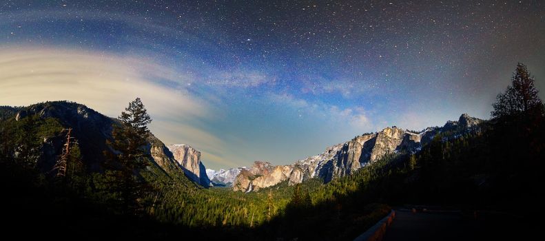 Image of Yosemite near sunrise with milky way and clouds over valley