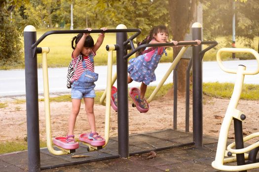 Happy smiling girls playing on playground equipment in the school before class. Children are happy and ready to learn. Back to school.