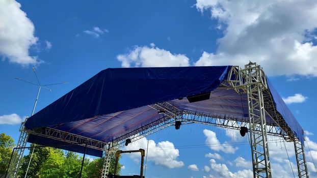 Summer stage in the park for events. Metal construction with a canopy
