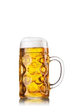 Mug with beer on white background. Beautiful foam and drops of moisture on a glass