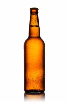 Cold bottle of beer with drops isolated on white background.