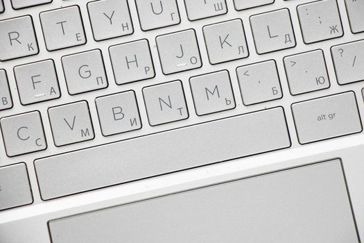 Laptop and notebook computer keyboard close-up, texts, keys and gray board.