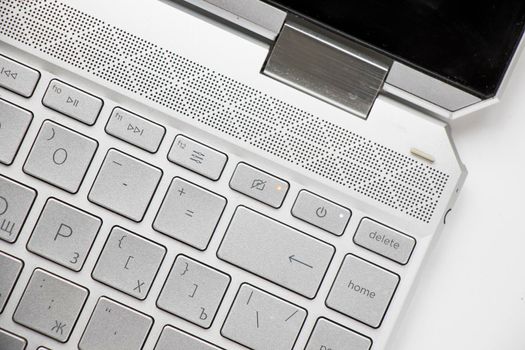 Laptop and notebook computer keyboard close-up, texts, keys and gray board.