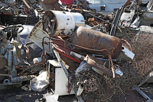 Scrap metal waste is stored in a recycling yard waiting to be melted down to manufacture new products