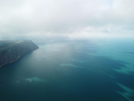 Aerial panoramic view of beautiful sunset above sea. Beautiful seascape. Sun glare, small waves on the water surface. Evening. Horizon. Nobody. No people. Copy space. Never-ending beauty of nature