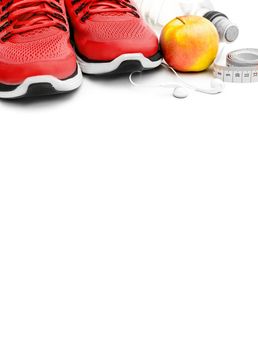 Trendy sport objects for running isolated on white background with copy space. Red shoes, bottle of water and apple composition