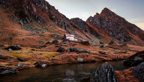Scenic view of building near lake in mountains