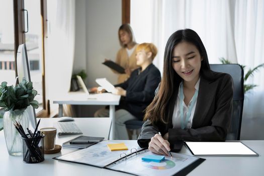 Pleased businesswoman working with modern device in office.