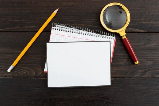 Blank Paper With Stationery On Table Presenting Information.