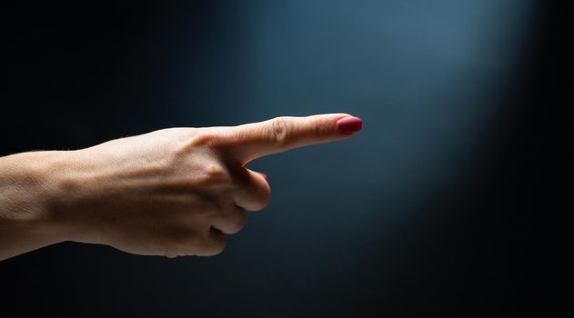 Hand shows direction with finger. Concept of gesture communication with no words