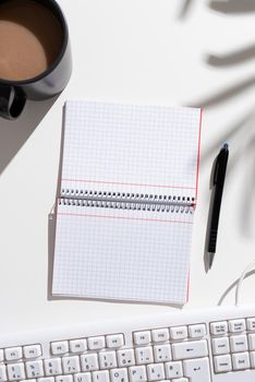 Notebook With New Ideas On Both Sides On Desk With Coffee, Pen And Keyboard