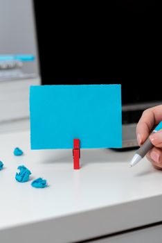 Woman Holding Pen On Desk With Paperwraps And Note With Important Data.