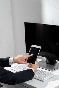 Woman Holding Mobile Phone And Pointing With One Finger On Important News.