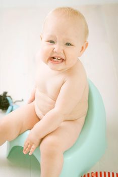 Cute emotional baby training to piss into pot
