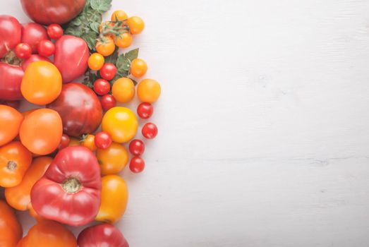 variation of fresh ripe tomatoes on wooden background