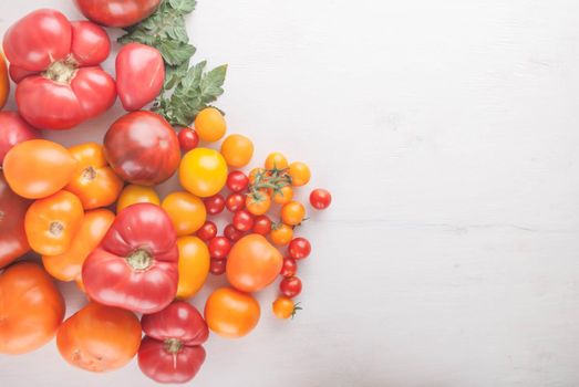 variation of fresh ripe tomatoes on wooden background