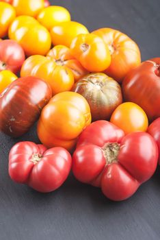 variation of fresh ripe tomatoes on wooden background