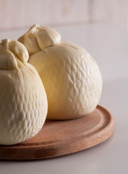 fresh italian cheesse caciocavallo on wooden board