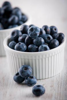 fresh blueberry in white plates on wooden table