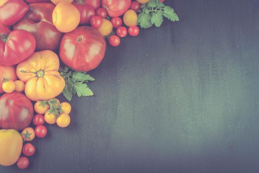 variation of fresh ripe tomatoes on wooden background