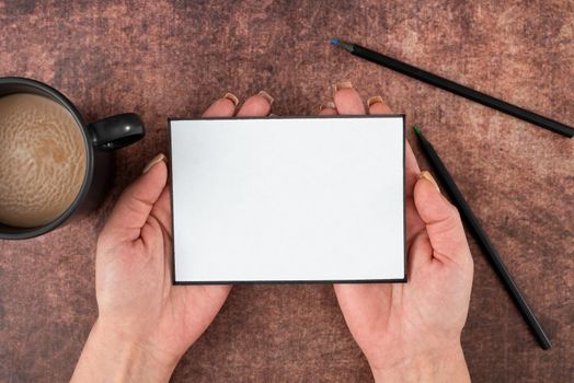 Woman With Blank Paper, Pencil And Coffee Cup Over Wooden Background.