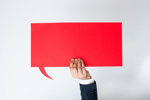 Businessman Holding Speech Bubble With Important Messages With One Hand.