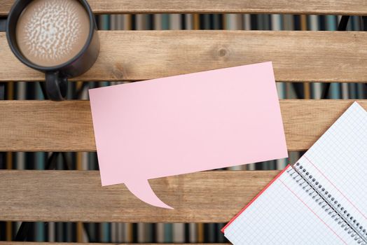 Speech Bubble With Important Announcement Placed On Table With Coffee.