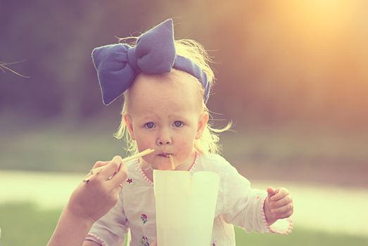 toddler is eating thai food outdoor. High quality photo