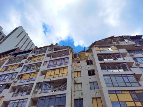 Kyiv, Ukraine - July 10, 2022: A residential building damaged by an russuian rocket in the Kyiv. The rocket hit the house.
