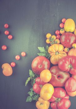 variation of fresh ripe tomatoes on wooden background