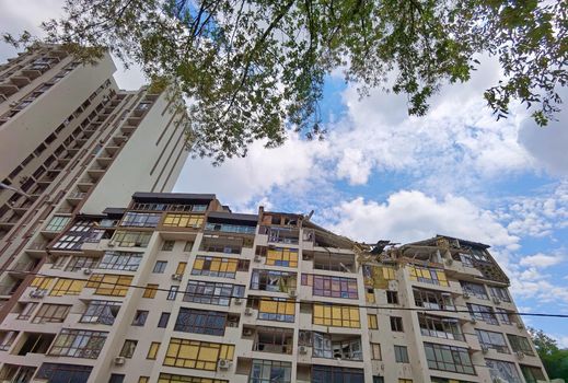 Kyiv, Ukraine - July 10, 2022: A residential building damaged by an russuian rocket in the Kyiv. The rocket hit the house.