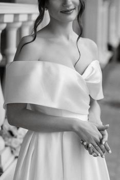 portrait of a young bride girl in a short white dress on a rainy day