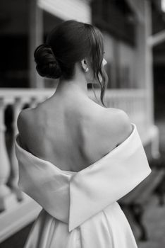 portrait of a young bride girl in a short white dress on a rainy day