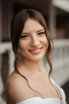 portrait of a young bride girl in a short white dress on a rainy day