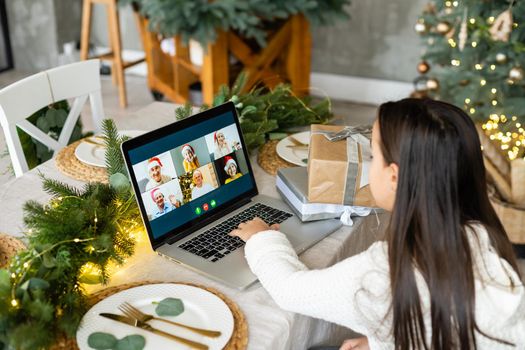 Little girl talking and happy New Year on a laptop. Online congratulations.