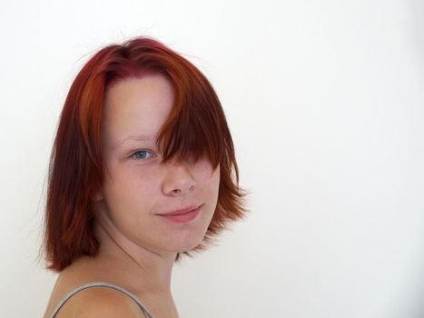 Portrait of smiling teenage girl on white background, copy space