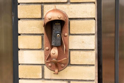 electronic modern intercom on the door of a private house, an intercom panel with a video camera on the brick fence of the fence of a private house