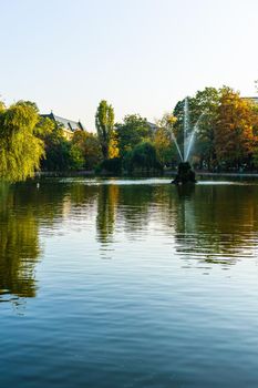 Vivid green landscape near the lake in Cismigiu Garden (Gradina Cismigiu), a public park in the city center of Bucharest