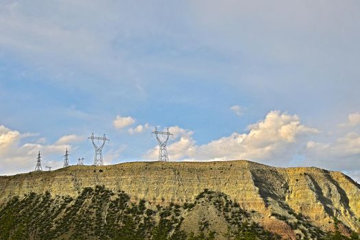 high-voltage power lines coming from a hydroelectric power plant, high-voltage transmission tower