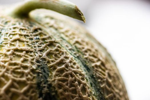 Textured fresh and ripe cantaloupe melons on concrete background