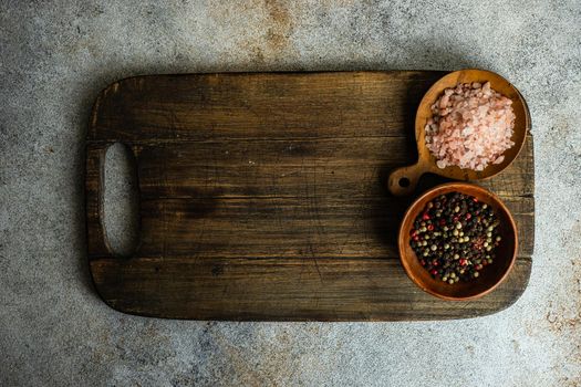 Cooking concept with spices and rosemary herb on concrete background