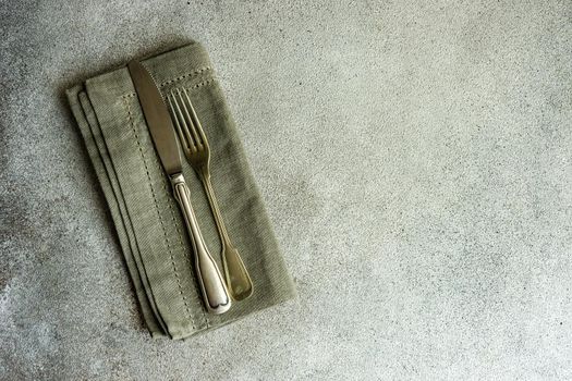 Overhead table setting in minimalistic style on concrete background