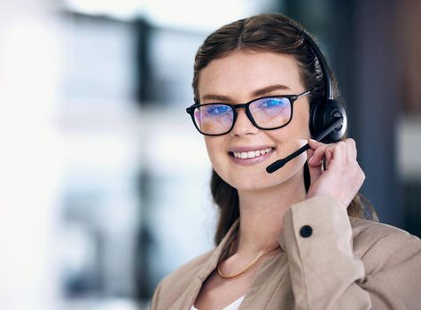 The nature of her work demands good communication skills. Portrait of a young call centre agent working in an office