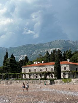 People walk along the beach of Villa Milocer. Montenegro. High quality photo