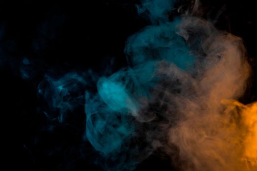 movement of a cloud of cigarette vapour in different colours degrading from orange to blue, on dark background. banner with illuminated coloured smoke. horizonte