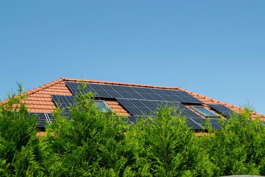 House roof with photovoltaic modules. Historic farm house with modern solar panels on roof and wall High quality photo