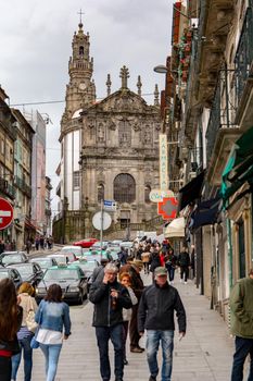 Porto,Portugal; 12/06/2016. People wlak for the street whit the Clerigos Tower in back.