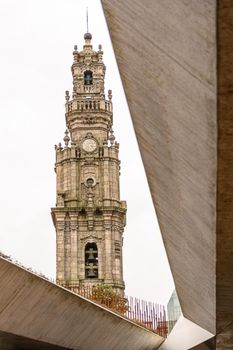 View of the beautiful baroque Church of Clerigos (Igreja dos Clerigos, in Portuguese) and iconic Clerigos Tower, one of the landmarks and symbols of Oporto city in Portugal. Sunset color in blue sky.