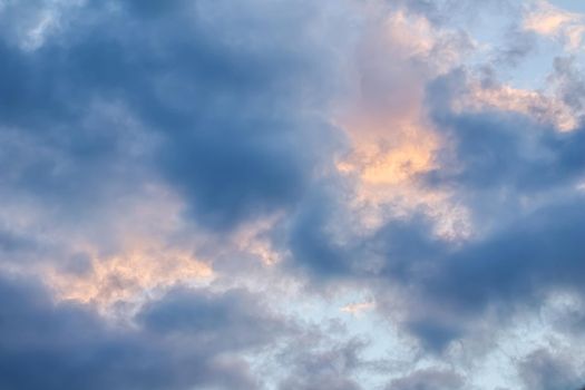 Cloudy sky background with sunlight through clouds at sunset