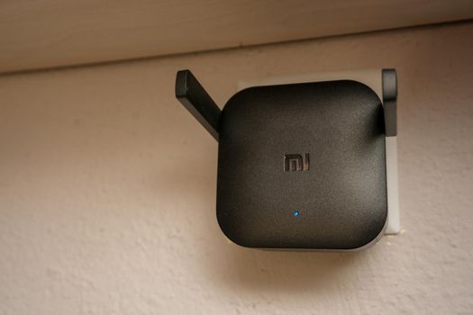 15 August 2021 Eskisehir Turkey. Xiaomi wifi extender plugged in at home close up view